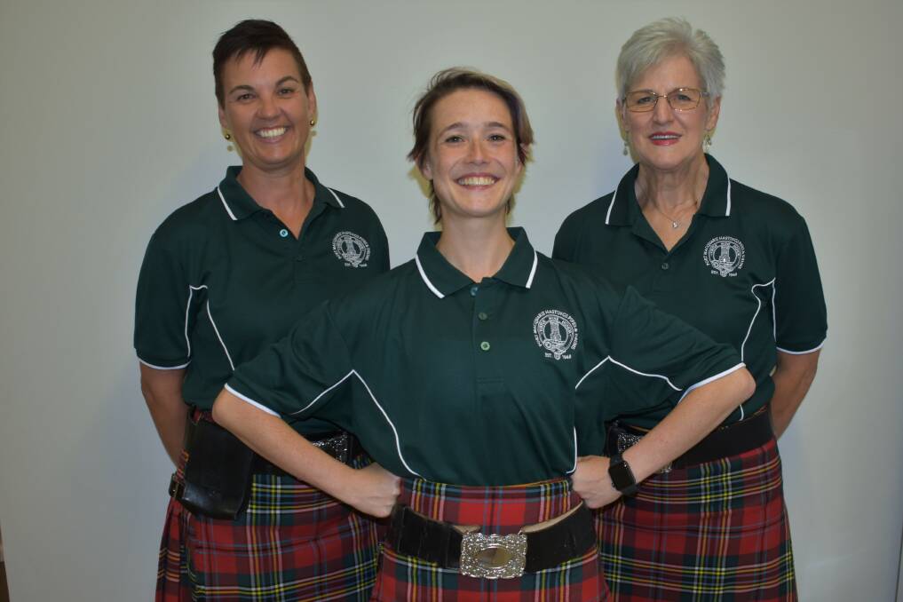 WORLD CHAMP: Highland dancer Joanna Buchan with Port Macquare-Hastings pipe sergeant Jenny McKenzie and pipe major Joy McKenzie.