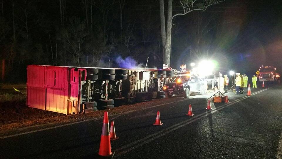 Crews work quickly: The cattle truck laying on its side. Photo: Fire and Rescue NSW Station 492 Wauchope