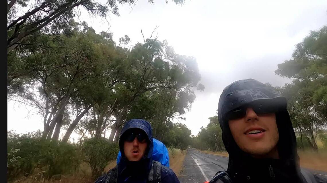 WET WEATHER: Blake Dobles and Nathan Harris-Dent on the road. Photo: Supplied.