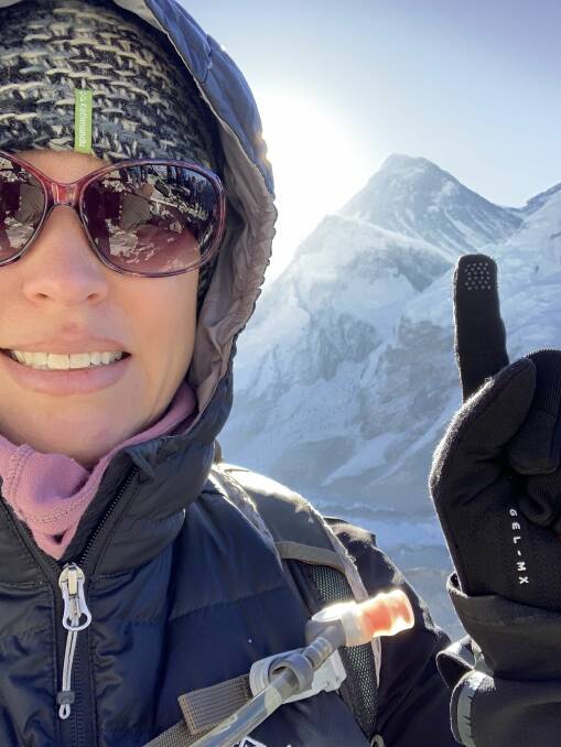 Atop the spine of the world: Claudia next to the summit of Mount Everest.