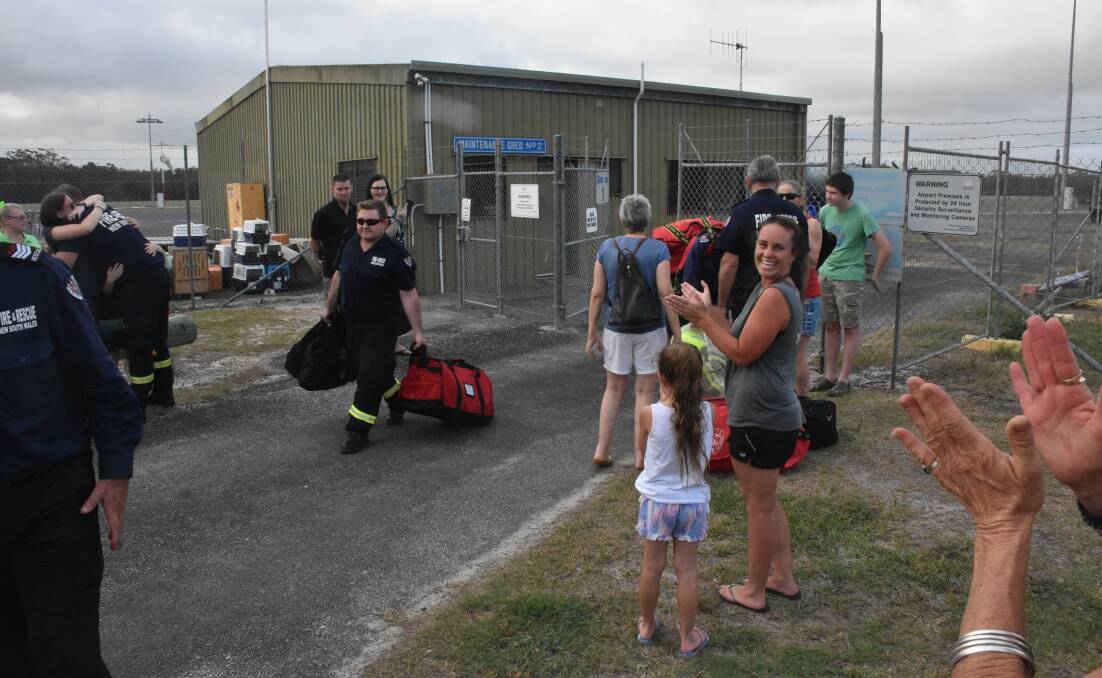 WELCOME BACK: Port Macquarie residents appauld returning firefighters.