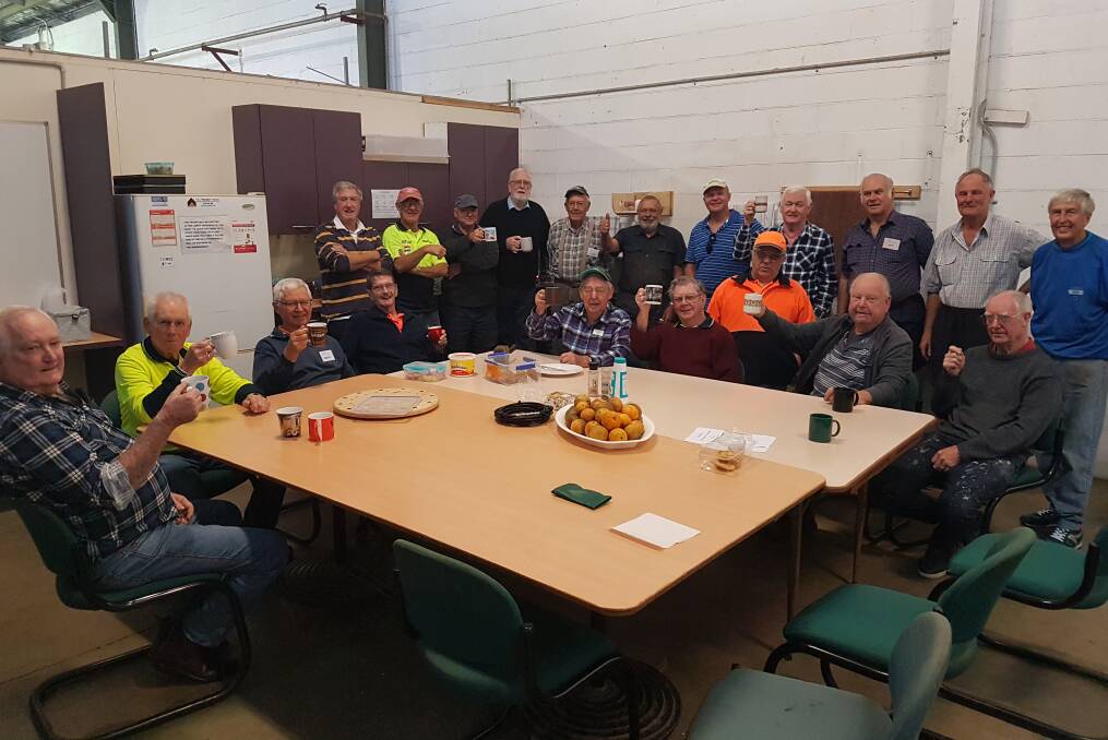 Coffee and biscuits: Port Macquarie Men's Shed members on a coffee break on June 11.