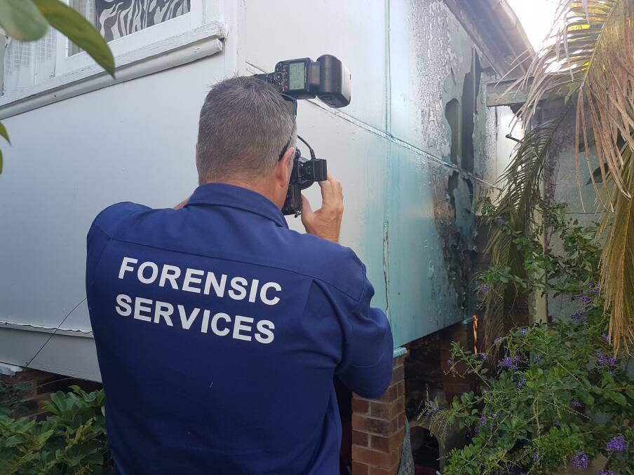Building fire: Police detectives investigating a building fire in Port Macquarie.