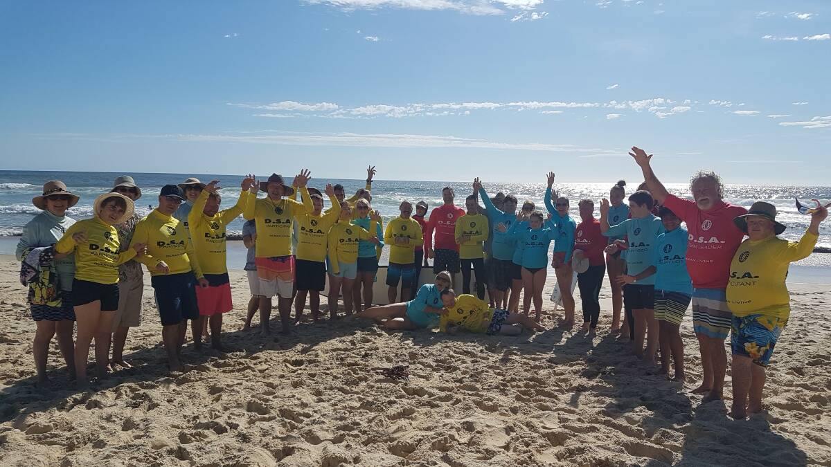 Volunteers and keen surfers hitting the waves at Flynns Beach in Port Macquarie.
