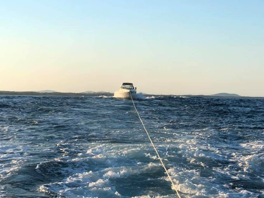 TOWED AWAY: The stranded cruiser being towed to Port Macquarie. Photo: Marine Rescue Port Macquarie.