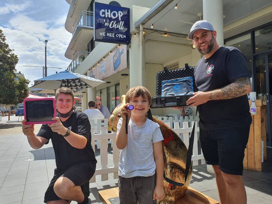 Jack Best, Arlo Strachan and Scott Horner solving the puzzles outside Chop and Chill.