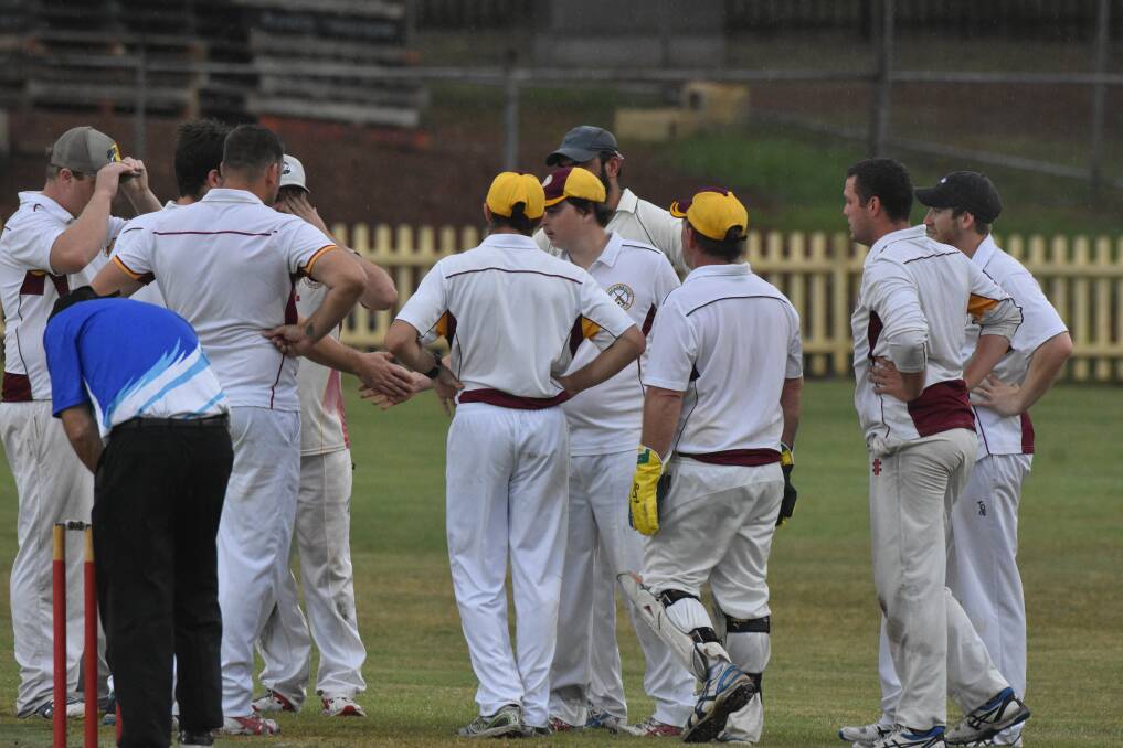 ONE GONE: Macquarie players congratulate each other after a wicket is taken.