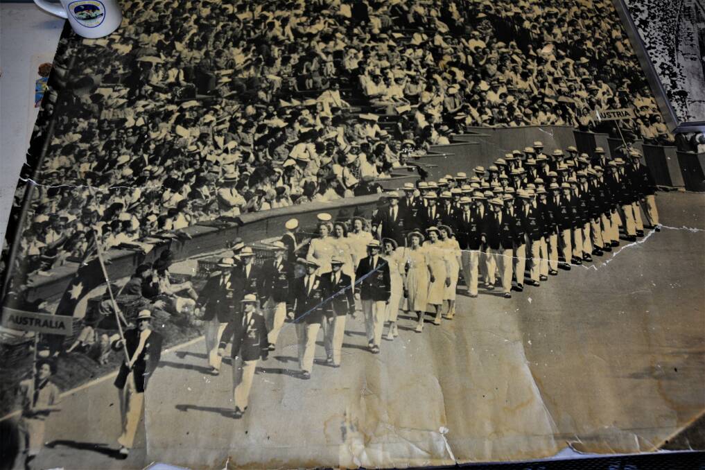 THE MOMENT: Les McKay leading the Australian Olympic team in 1948. A boy scout walks ahead with the Australia banner.