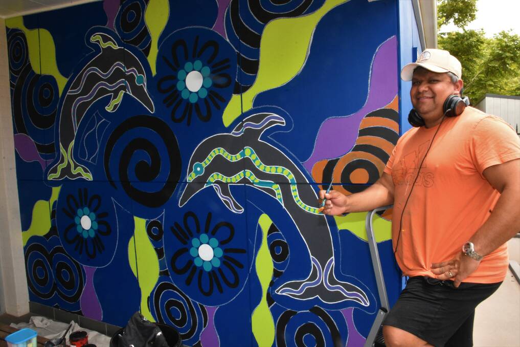 MURAL IS A GO: Dunghutti contemporary Aboriginal artist Jason Ridgeway painting at the Munster Street building.