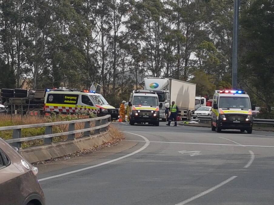 ROLLOVER: The two injured men are transported to Port Macquarie Base Hospital.
