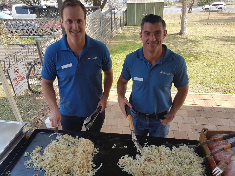 MANNING THE BBQ: Sam Wicks and Chris Youngs tossing onions at the Community Hair Project.