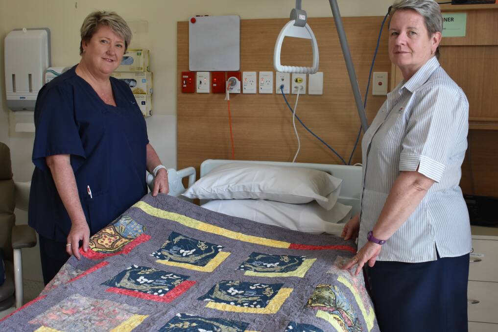 LOVED: Registered nurse Cath Gray and nursing unit manager Mary Trotter with one of the beloved quilts at the Wauchope District Memorial Hospital's Palliative Care unit. PHOTO: Laura Telford.