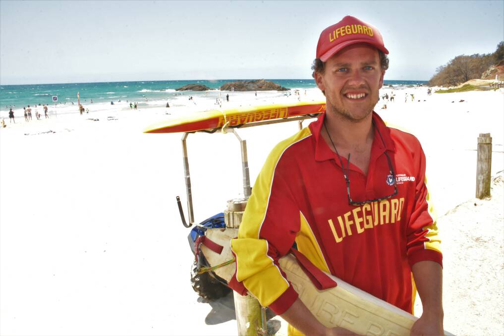 ON THE JOB: Lifeguard Jones Russell explains conditions at Town beach.