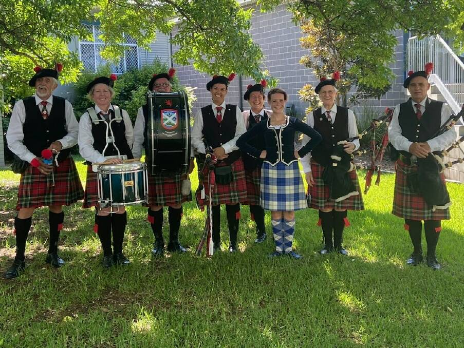 GREAT TEAM: Highland dancer Dr Joanna Buchan with members of the Port Macquarie-Hastings Pipes and Drums. Photo: Supplied/Port Macquarie-Hastings Pipes and Drums.