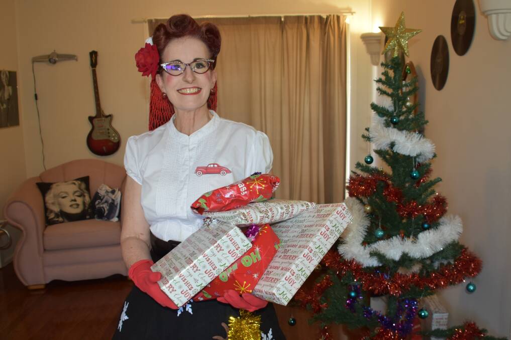 CHRISTMAS CHEER: Pin up model Ms Dale Velvet-Rose with some presents to be donated.