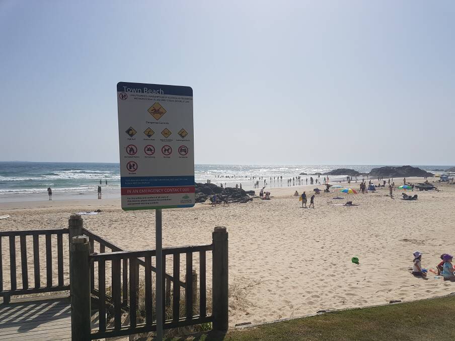 WARNING SIGNS: Swimmers and sunbathers at Town Beach in Port Macquarie.