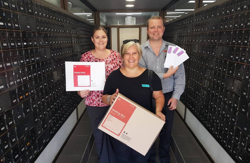 In the mail: Port Macquarie senior postal service officer Leacia Berruex, retail and business teacher Caroline Hudson and postal service officer Daniel Snow.