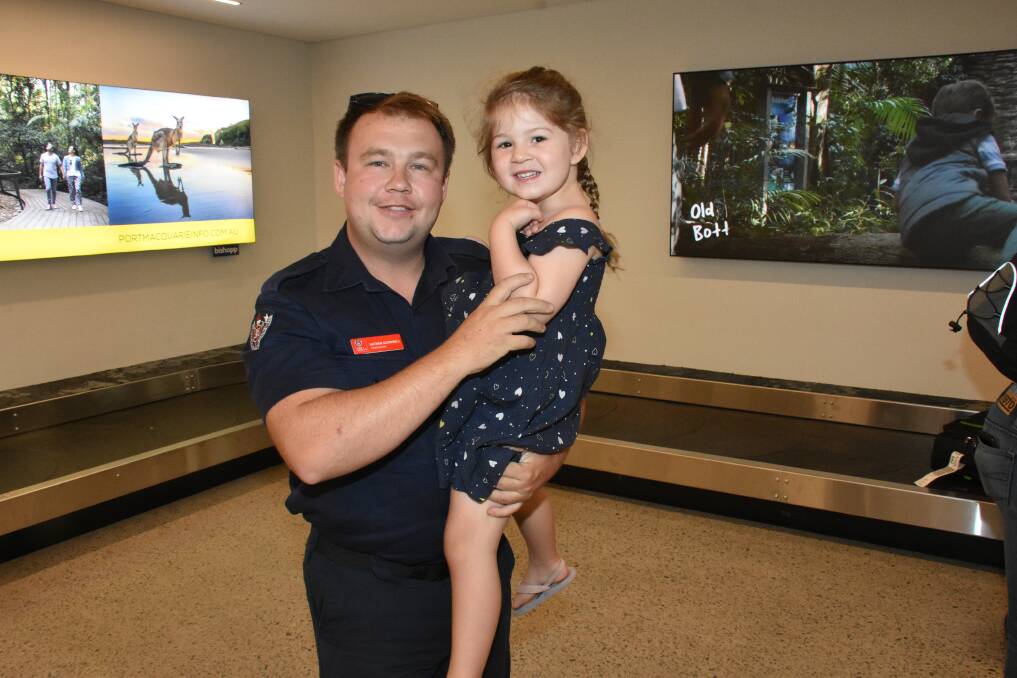 BACK FROM THE FIRES: Retained firefighter Nathan Goodsell returns home to daughter, Lacey in Port Macquarie.