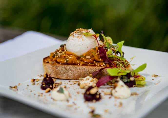 PERFECT BREAKFAST: Poached eggs on sourdough with honey spiced roasted pumpkin, beetroot puree, whipped feta and toasted seeds. Photo: Supplied.