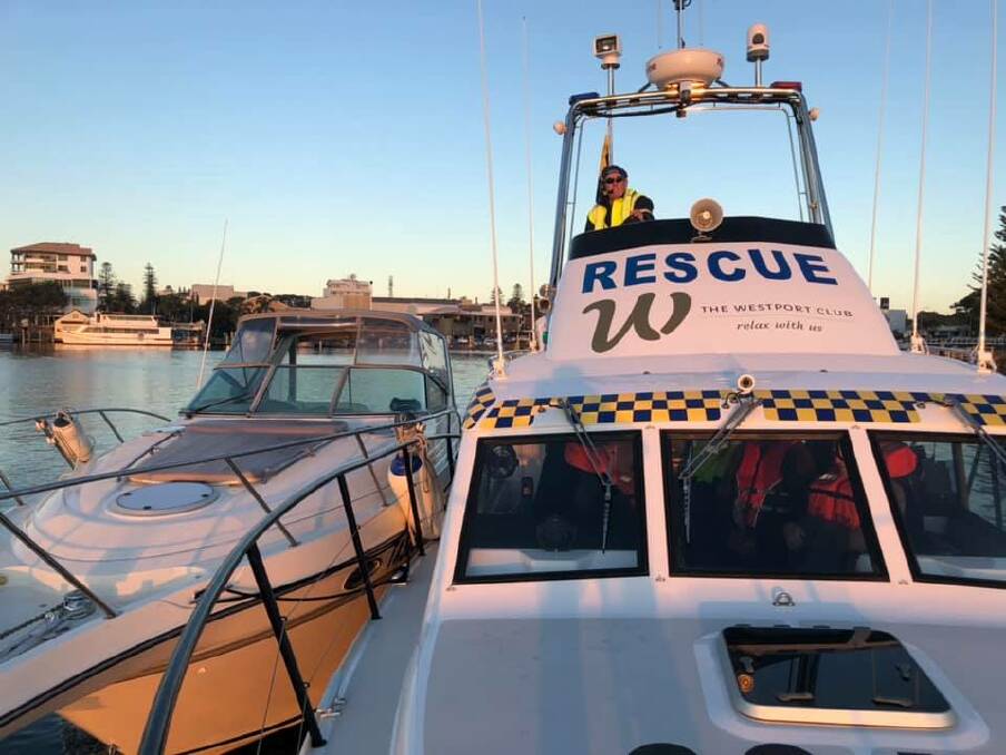 CLOSE PALS: The stranded cruiser next to Marine Rescues launch. Photo: Marine Rescue Port Macquarie.