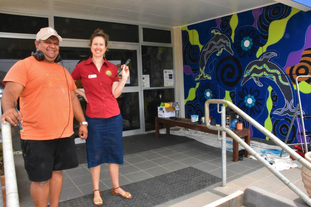 PRESCHOOL MURAL: Dunghutti contemporary Aboriginal artist Jason Ridgeway with business manager Cara Greenwell.