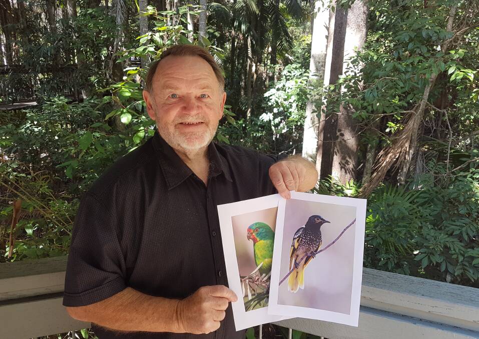 On the lookout: Survey coordinator Ken Monson with a photo of a Swift Parrot and Regent Honeyeater.