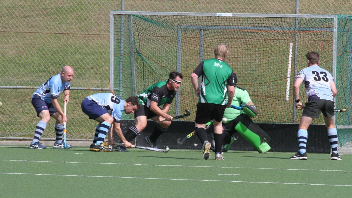 BATTLE IN THE GOALS: Open mens Lightning players struggle in front of the goal keeper on September 5. Photo: Port Macquarie Hastings Hockey Association.