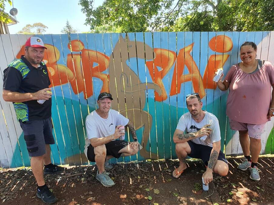 Young painters and artists assemble for laneway mural