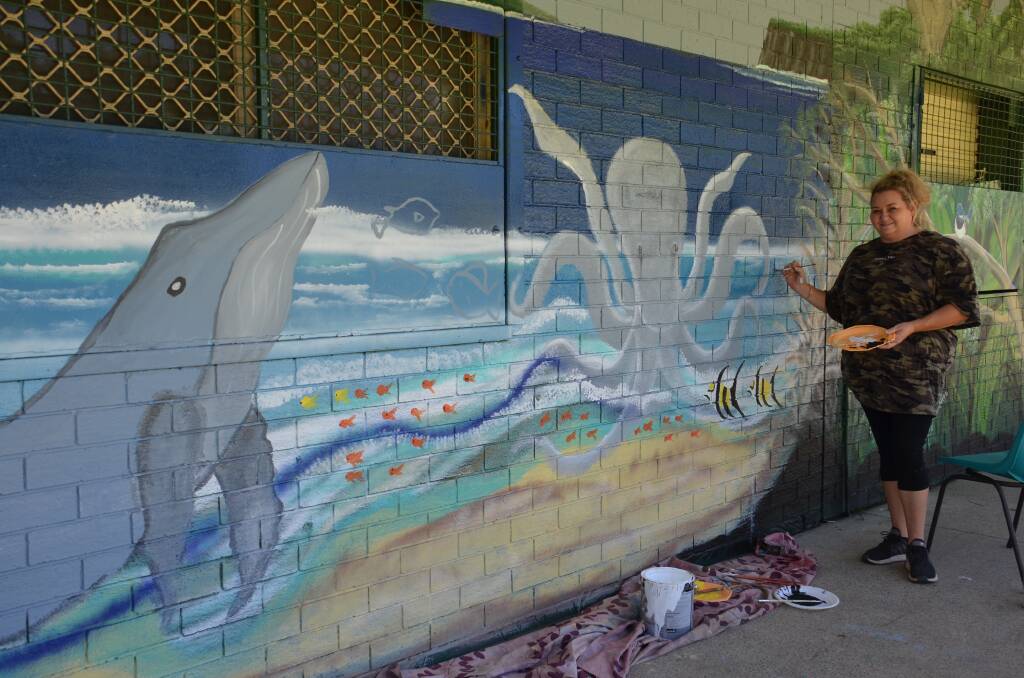 Kempsey artist Kim Marklew painting one section of the mural. 