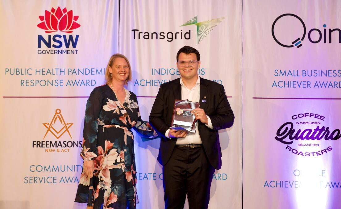 Transgrid head of Indigenous engagement and sustainability Heather Wagland presents Corey with his award. Photo: Supplied