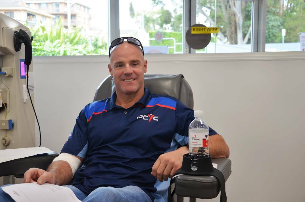 Emergency services challenge: Senior Constable Michael Dietrich giving blood at the start of the challenge in June.