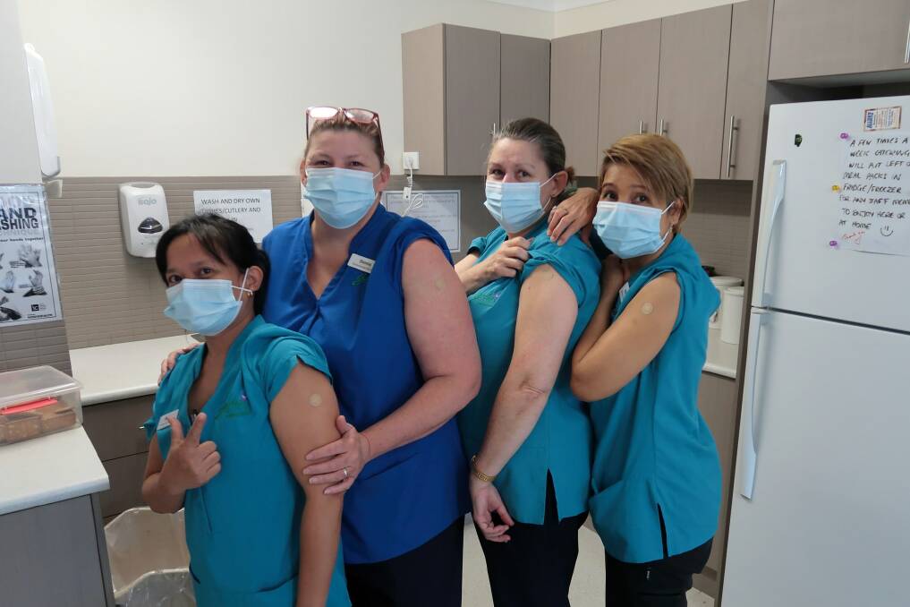 Vaccinated: Staff at Garden Village Port Macquarie roll up their sleeves. Photo: Supplied
