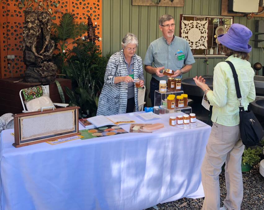 Bee friendly: Julia Watkins and Charles Watkins from Hastings Valley Amateur Beekeepers Association chat to a community member during an information day at Bonny Hills Garden Centre. Photo: Bonny Hills Garden Centre