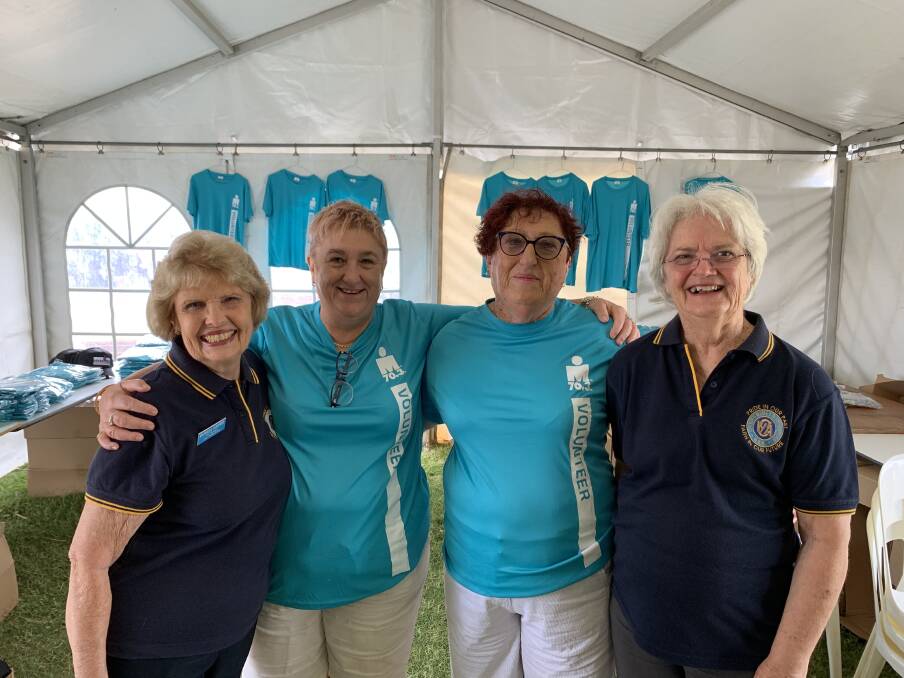 Behind the scenes: CWA Port Macquarie Evening Branch's Gay Cowan, Ann Stewart, Robyn Stewart and Patricia Godfrey unpack boxes of gear in the Ironman tent ready for volunteers to collect. Photo: CWA Port Macquarie Evening Branch
