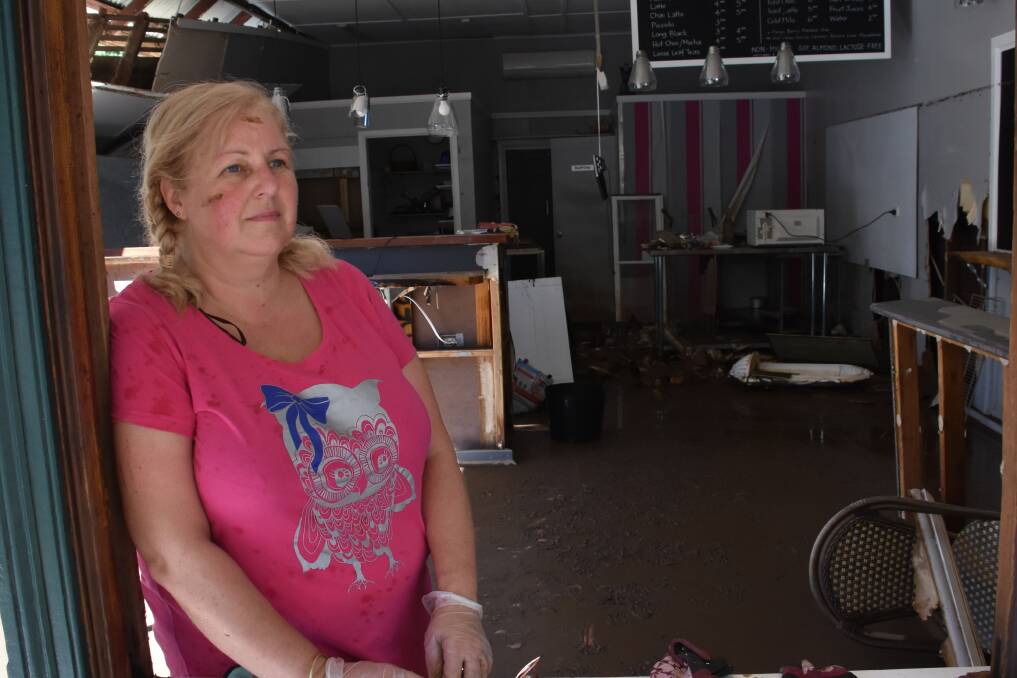 Flood aftermath: Jenelle Nosworthy from Miss Nellie's Cafe surveys the damage to her Kendall business. Photo: Rob Dougherty