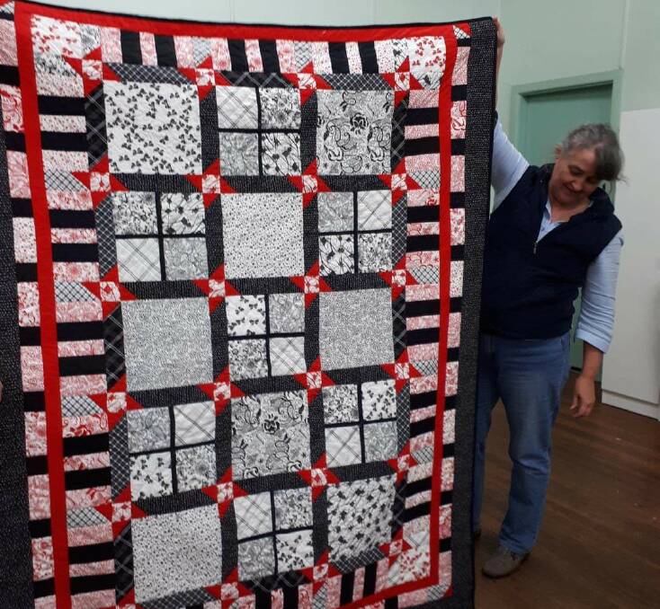 Quilt creation: Wauchope Patchwork Quilters member Janelle Thomas displays one of her quilts. Photo: Wauchope Patchwork Quilters