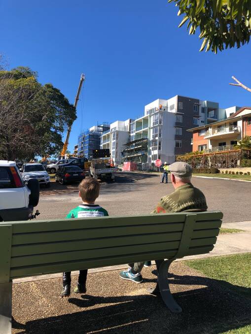 Talking point: Onlookers watch the dismantling of the tower crane.