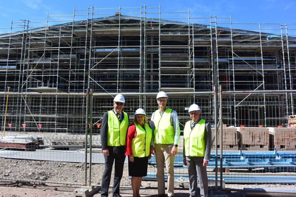 Building takes shape: Port Macquarie RSL Sub-branch president Greg Laird, mayor Peta Pinson, RSL LifeCare executive general manager - retirement living Tim Bannigan and Port Macquarie RSL Sub-branch treasurer/trustee Colin Clark with the community building in the background.