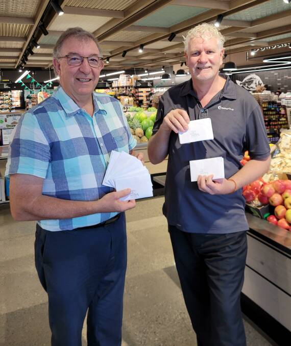 Wauchope Rotarian Neville Parsons and Hastings Co-op business and community development manager Tim Walker with the donated fuel vouchers.