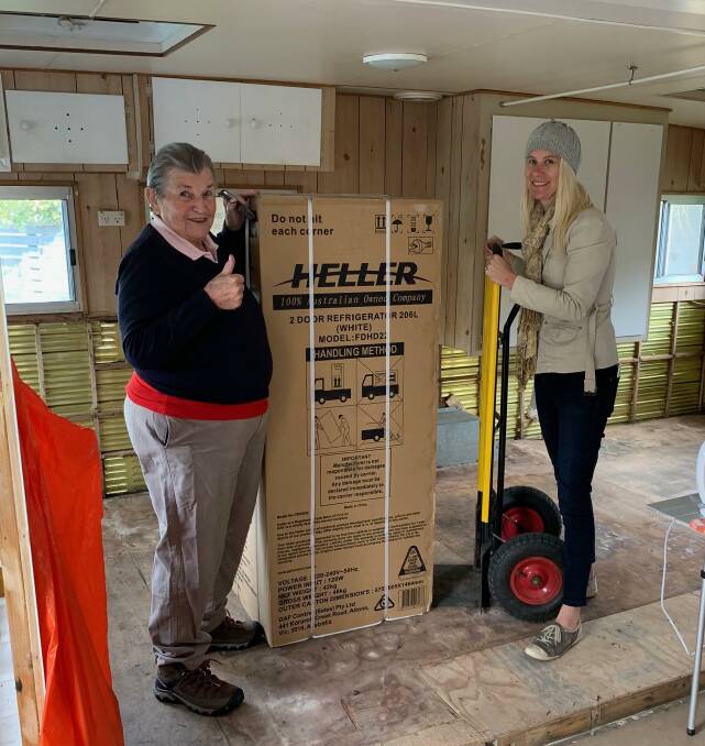 Helping hand: Recovery support worker Nette McCoubrie (right) delivers a fridge from Make a Difference to Margaret Patrick at Brigadoon Holiday Park.