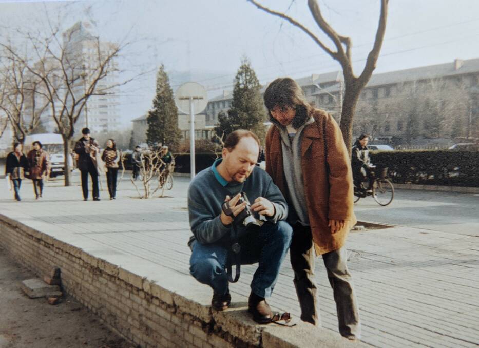 The then ABC Radio China correspondent Michael Cavanagh and camera operator Sebastian Phua examine and experiment with what was at the time the latest small digital camera.