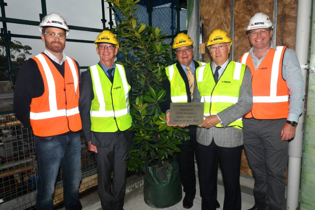 Unique development: Watpac project manager Paul Zvirzdinas, Garden Village chief executive officer Tim Everson, board members Neil Porter and Gordon Findlay and Watpac regional manager NSW Amos Frankel mark the milestone in the construction process.