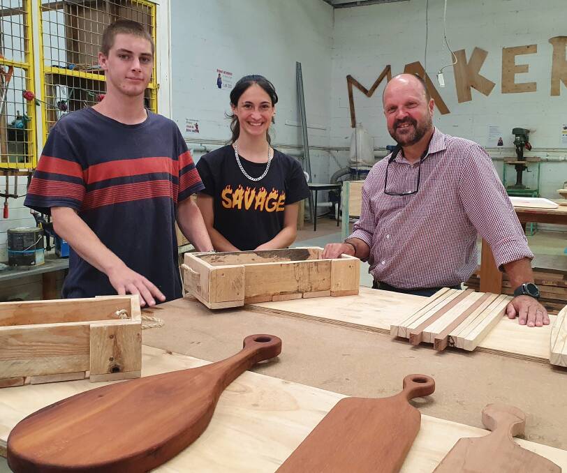 Honing skills: Construction pathway program students Jayk Murray and Aurora Torres, and trainer Craig Somerville showcase woodwork projects.
