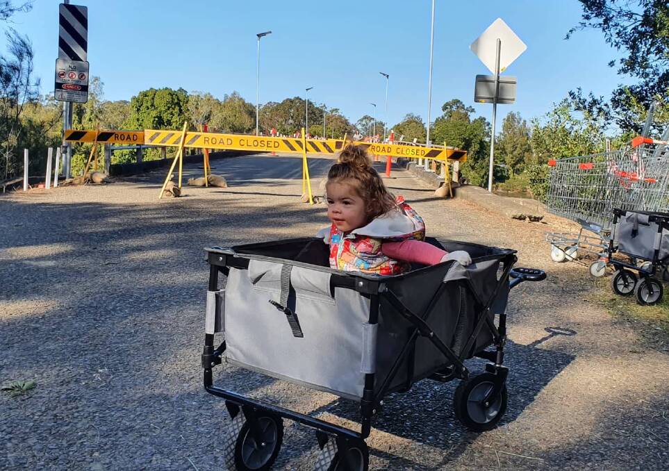 Daily life: Lily Stewart tests out a trolley available for residents at Rawdon Island bridge which is closed to traffic.