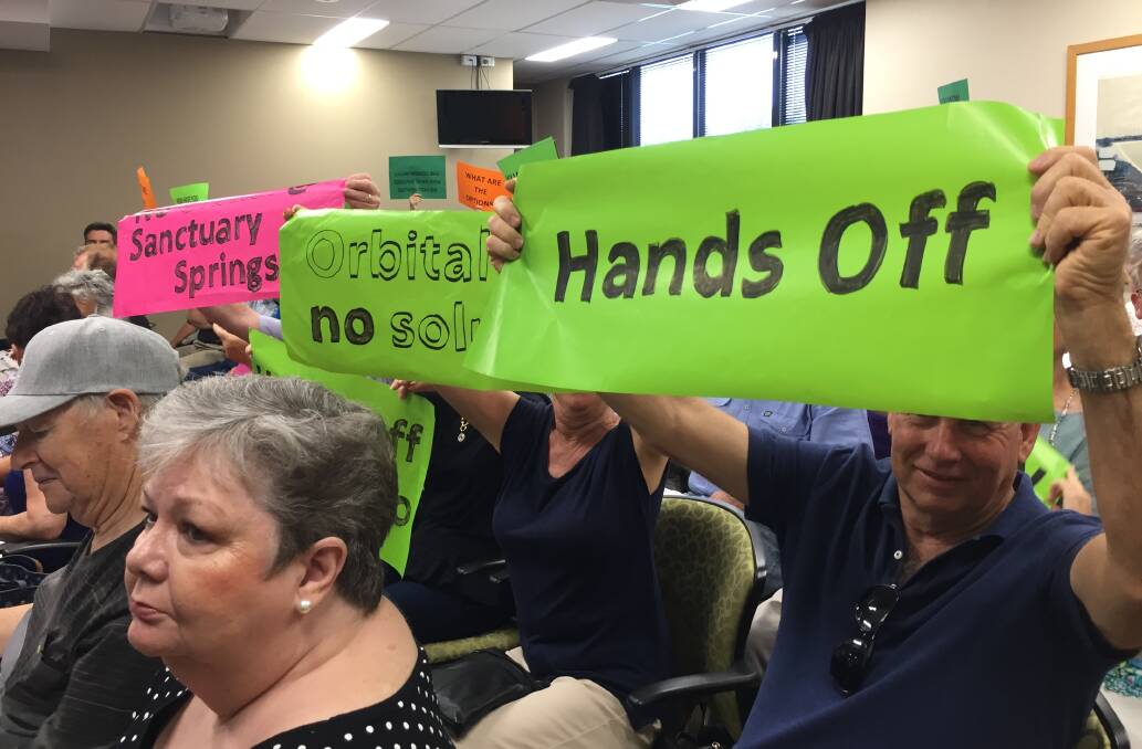 Unhappy: Residents worried about the proposed orbital road make their position clear during a council meeting.