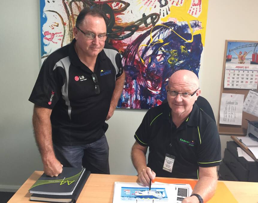 Long-term asset: Solar Bright Port Macquarie sales manager Craig King and Endeavour Mental Health Recovery Clubhouse director Rob Moorehead plan for the solar panel installation.