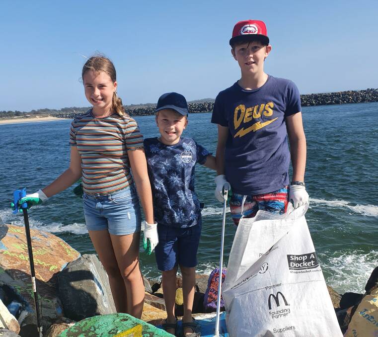 Keen volunteers: Madeline Towers, Troy Towers and Noah Barter focus on cleaning up rubbish along the breakwall.