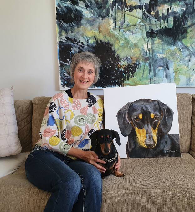 Canine celebration: Artist Jean Ballands and her dachshund Lewis, with his portrait in the background, ahead of ArtWalk 2020.
