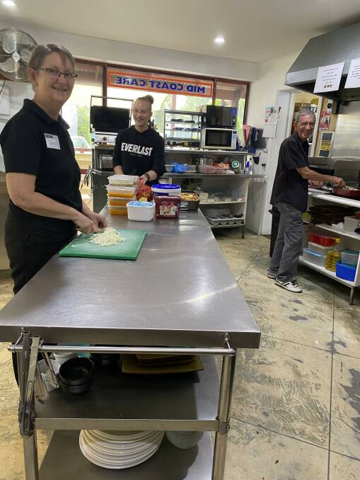 People matter: Tara Hoy, Steff Steele and John Thompson prepare takeaway meals to help flood-affected residents.