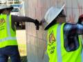 Volunteers assist with removing graffiti from community spaces and places. Picture supplied